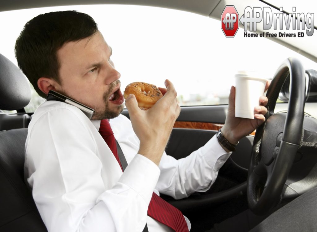 man eating donut driving